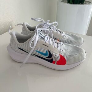 Nike Kids White Sneakers with Red and Blue Accents